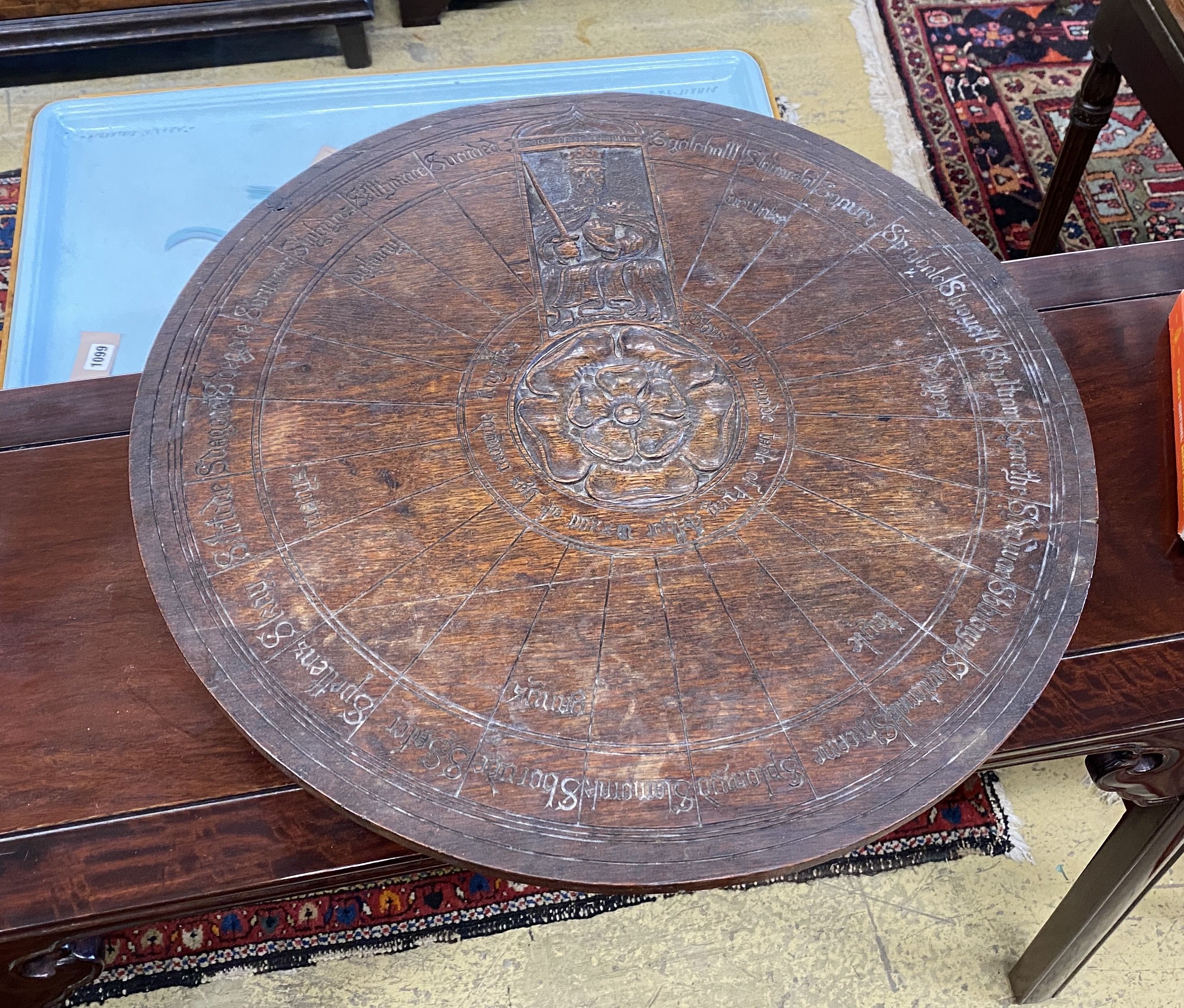 An early 20th century carved oak lazy Susan modelled on King Arthur’s round table, diameter 55cm, height 14cm